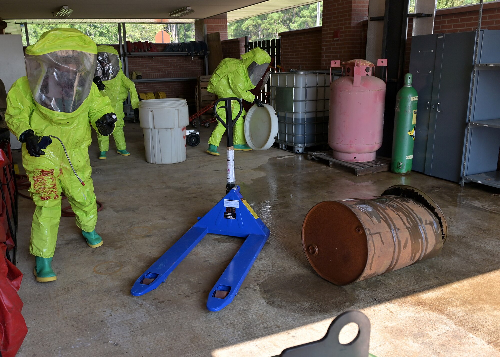 Firefighters assess a simulated hazardous materials spill.