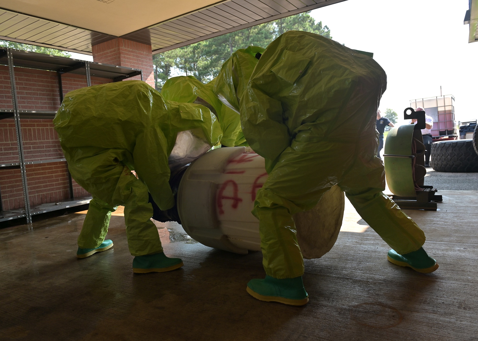 Firefighters contain a simulated hazardous materials spill.