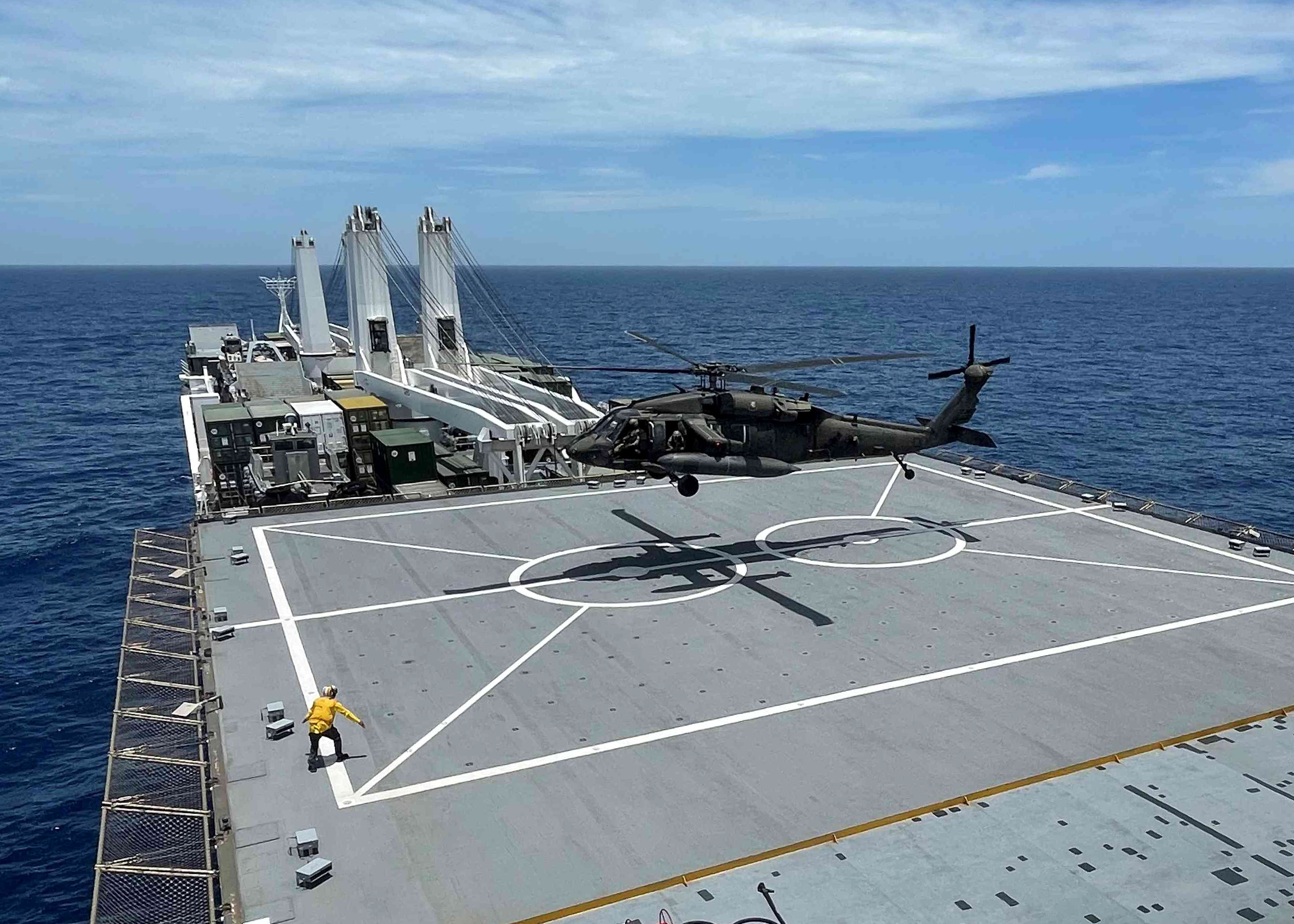 A UH-60 Blackhawk helicopter performs deck landing qualifications aboard USNS Sisler (T-AKR 311).