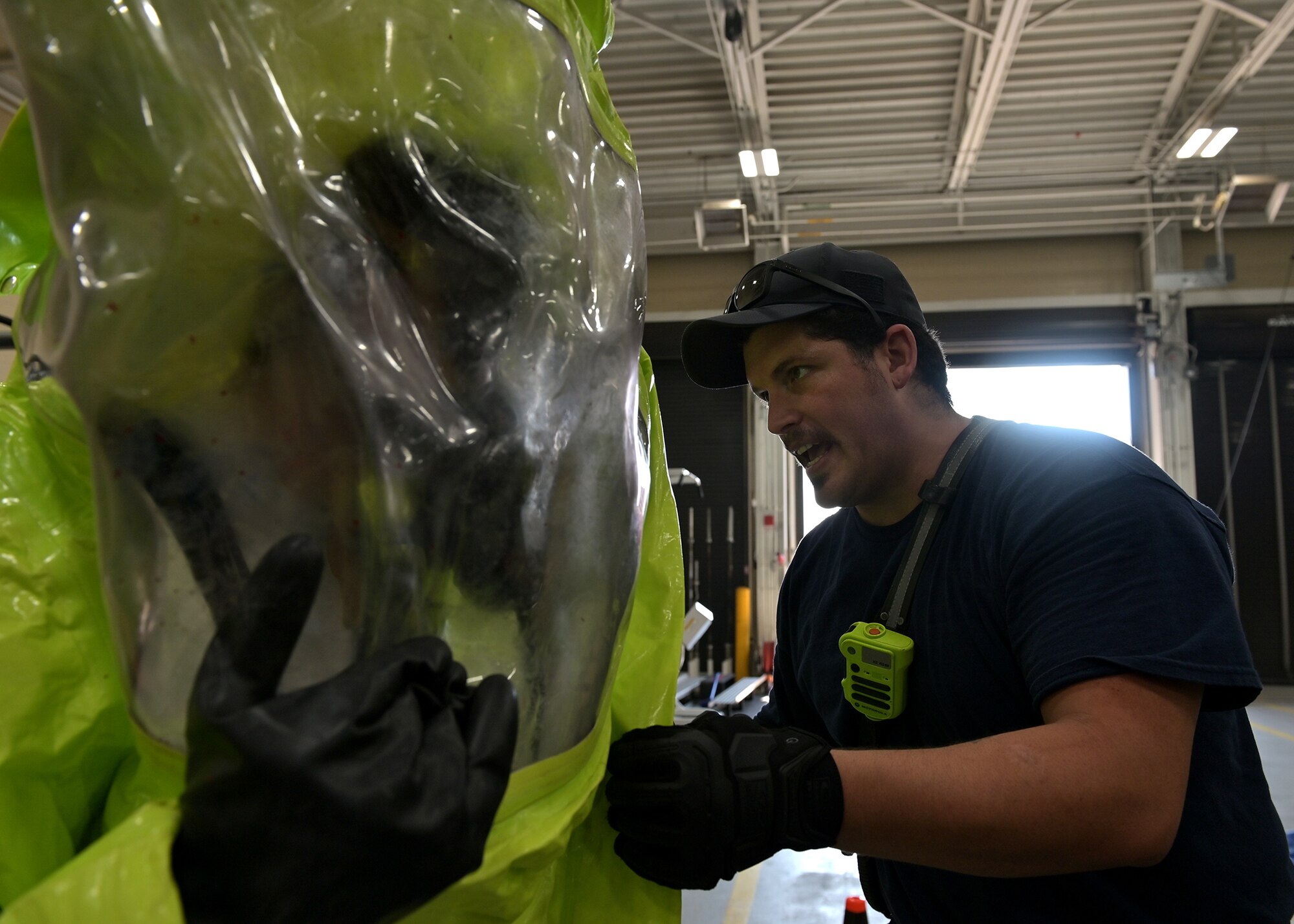 Firefighters communicate while entering the decontamination zone.