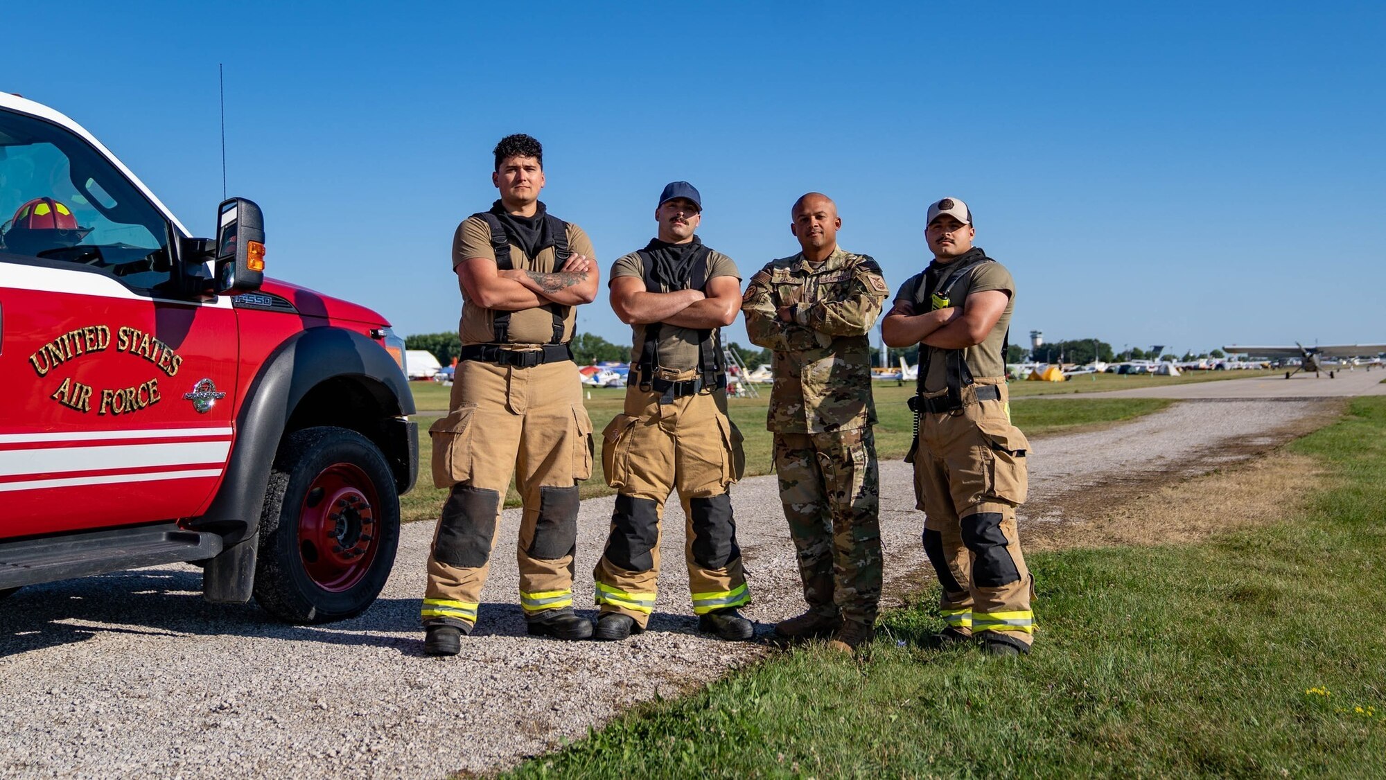 Firefighters from across the Air Education and Training Command pose for a photo in Oshkosh, Wisconsin, July 29, 2023. They were the four initial first responders to a fatal general aviation rotary wing midair accident on the Oshkosh grounds. (U.S. Air Force photo by Airman 1st Class Elizabeth Davis)