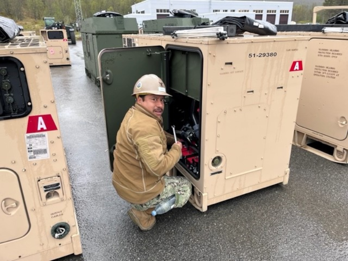 CM2 Bonifacio Garciacantoran conducts maintenance on a 60 kilowatt Advanced Medium Mobile Power System.