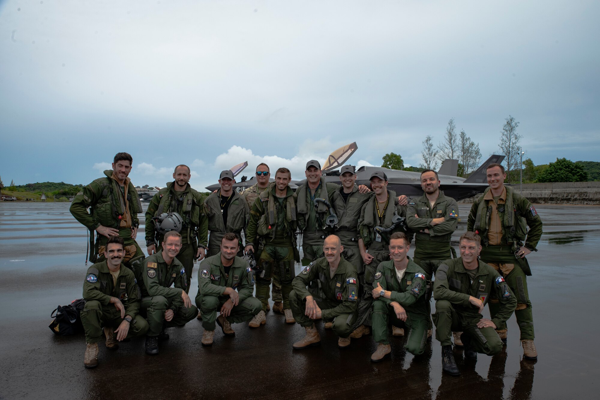 U.S. Air Force F-35A Lighting II pilots from the 419th Fighter Wing, and French Air and Space Force Dassault Rafale pilots pose for a photo at Roman Tmetuchl International Airport in Koror, Palau, July 7, 2023. The multi-national team arrived in Palau for Northern Edge 23-2, a multilateral exercise that enhances interoperability and cooperation and tests defensive readiness in the Indo-Pacific region. (U.S. Air Force photo by 1st Lt. Michelle Chang)