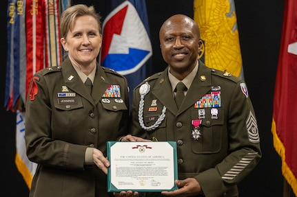 Brig. Gen. Paige M. Jennings, U.S. Army Financial Management Command commanding general, presents a Legion of Merit to Command Sgt. Maj. Kenneth F. Law, USAFMCOM senior enlisted advisor, during his retirement ceremony at the Maj. Gen. Emmett J. Bean Federal Center in Indianapolis March 31, 2023. Law retired from active duty after more than 30 years of service. (U.S. Army photo by Mark R. W. Orders-Woempner)