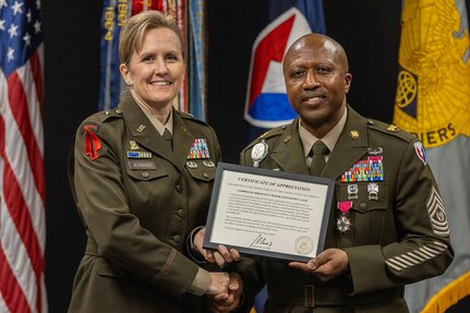 Brig. Gen. Paige M. Jennings, U.S. Army Financial Management Command commanding general, presents a letter of appreciation from President Joe Biden to Command Sgt. Maj. Kenneth F. Law, USAFMCOM senior enlisted advisor, during his retirement ceremony at the Maj. Gen. Emmett J. Bean Federal Center in Indianapolis March 31, 2023. Law retired from active duty after more than 30 years of service. (U.S. Army photo by Mark R. W. Orders-Woempner)