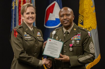 Brig. Gen. Paige M. Jennings, U.S. Army Financial Management Command commanding general, presents a letter of appreciation from Christine E. Wormuth, Secretary of the Army, to Command Sgt. Maj. Kenneth F. Law, USAFMCOM senior enlisted advisor, during his retirement ceremony at the Maj. Gen. Emmett J. Bean Federal Center in Indianapolis March 31, 2023. Law retired from active duty after more than 30 years of service. (U.S. Army photo by Mark R. W. Orders-Woempner)