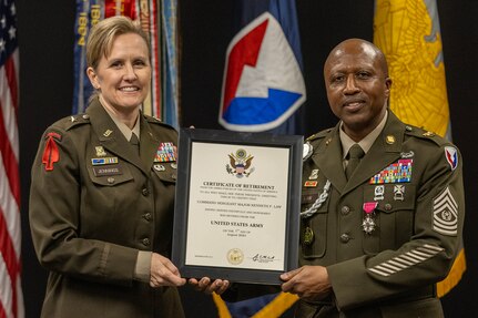 Brig. Gen. Paige M. Jennings, U.S. Army Financial Management Command commanding general, presents a certificate of retirement to Command Sgt. Maj. Kenneth F. Law, USAFMCOM senior enlisted advisor, during his retirement ceremony at the Maj. Gen. Emmett J. Bean Federal Center in Indianapolis March 31, 2023. Law retired from active duty after more than 30 years of service. (U.S. Army photo by Mark R. W. Orders-Woempner)