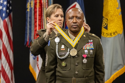 Brig. Gen. Paige M. Jennings, U.S. Army Financial Management Command commanding general, presents a Distinguished Member of the Finance Regiment award to Command Sgt. Maj. Kenneth F. Law, USAFMCOM senior enlisted advisor, during his retirement ceremony at the Maj. Gen. Emmett J. Bean Federal Center in Indianapolis March 31, 2023. Law retired from active duty after more than 30 years of service. (U.S. Army photo by Mark R. W. Orders-Woempner)