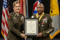 Brig. Gen. Paige M. Jennings, U.S. Army Financial Management Command commanding general, presents a Distinguished Member of the Finance Regiment award to Command Sgt. Maj. Kenneth F. Law, USAFMCOM senior enlisted advisor, during his retirement ceremony at the Maj. Gen. Emmett J. Bean Federal Center in Indianapolis March 31, 2023. Law retired from active duty after more than 30 years of service. (U.S. Army photo by Mark R. W. Orders-Woempner)