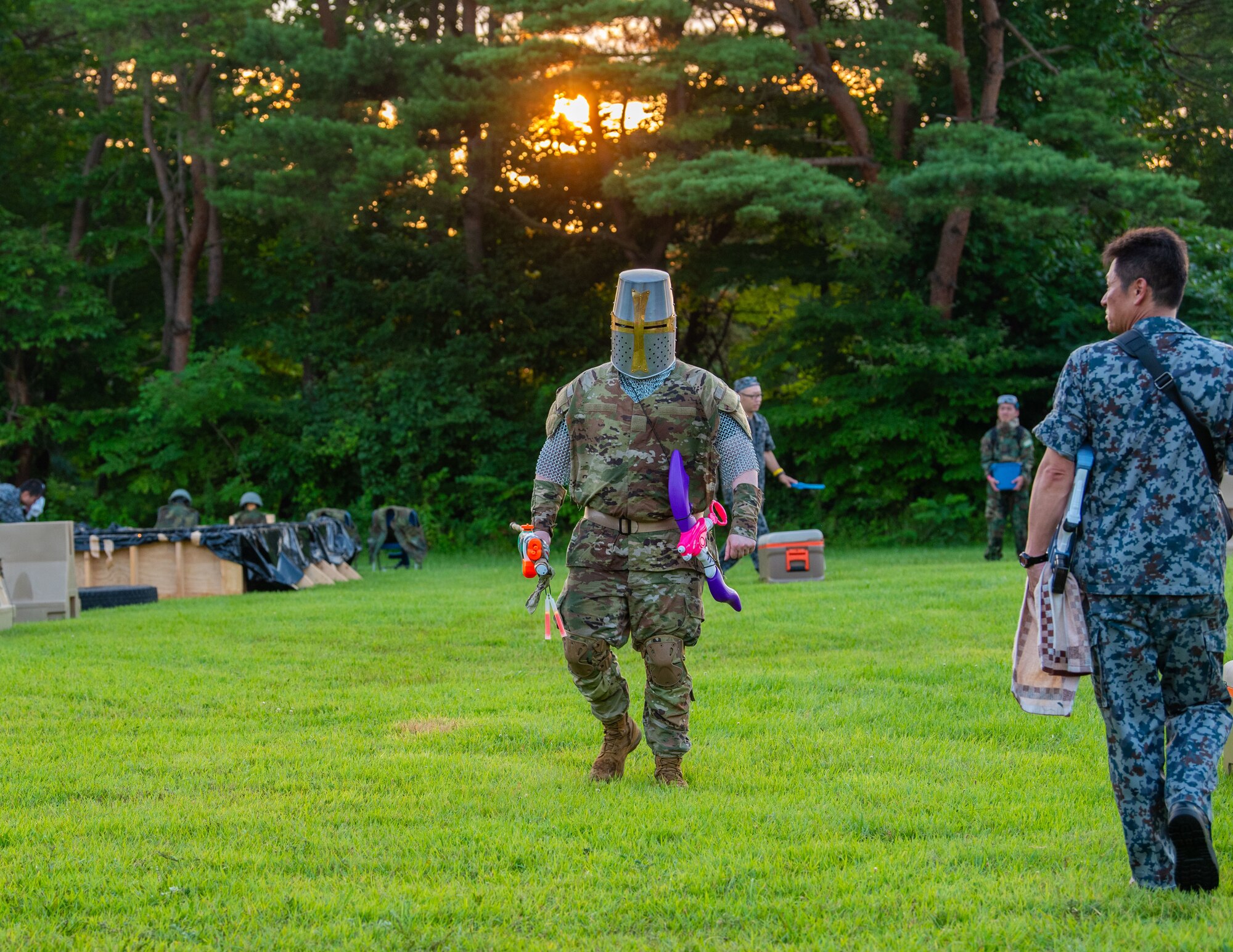 A Team Misawa member crosses a field prior to Misawa’s first joint enlisted bilateral combat dining-in event at Misawa Air Base, Japan, July 28, 2023.