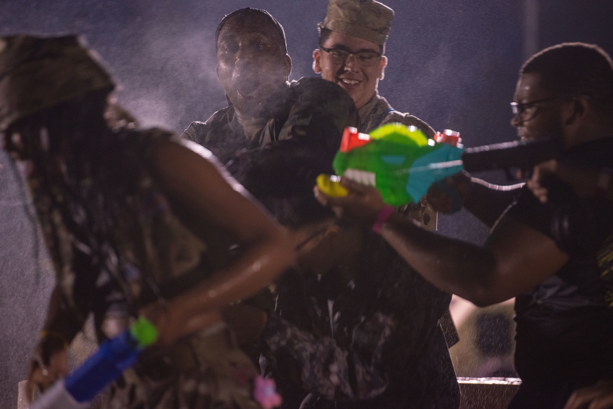 Team Misawa members shoot water at other participants during Misawa’s first joint enlisted bilateral combat dining-in event at Misawa Air Base, Japan, July 28, 2023.