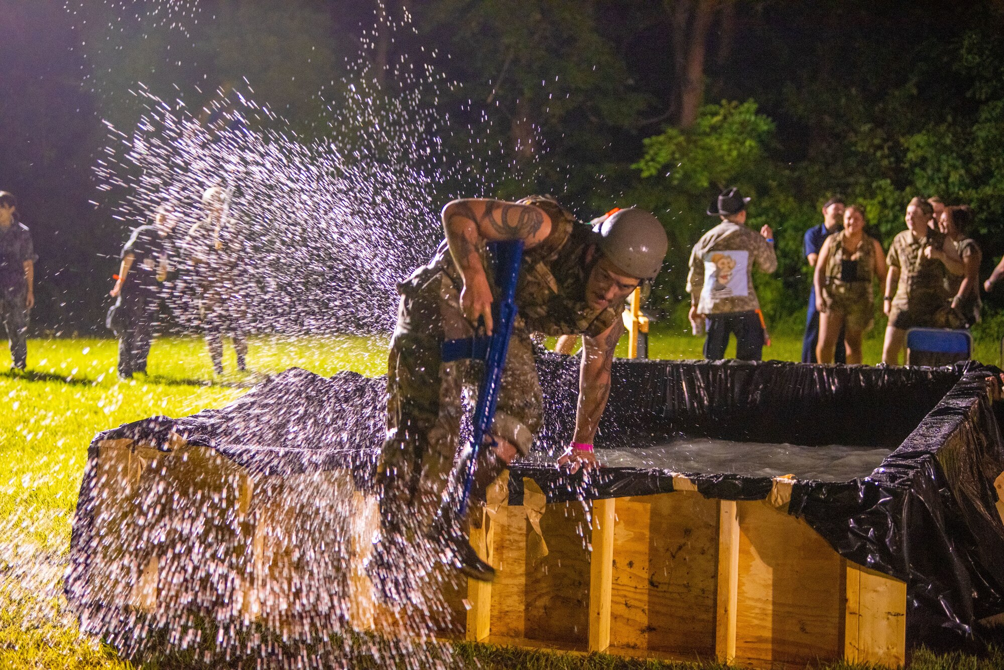 A member of Team Misawa jumps out of the pool in an obstacle course during Misawa’s first joint enlisted bilateral combat dining-in event at Misawa Air Base, Japan, July 28, 2023.