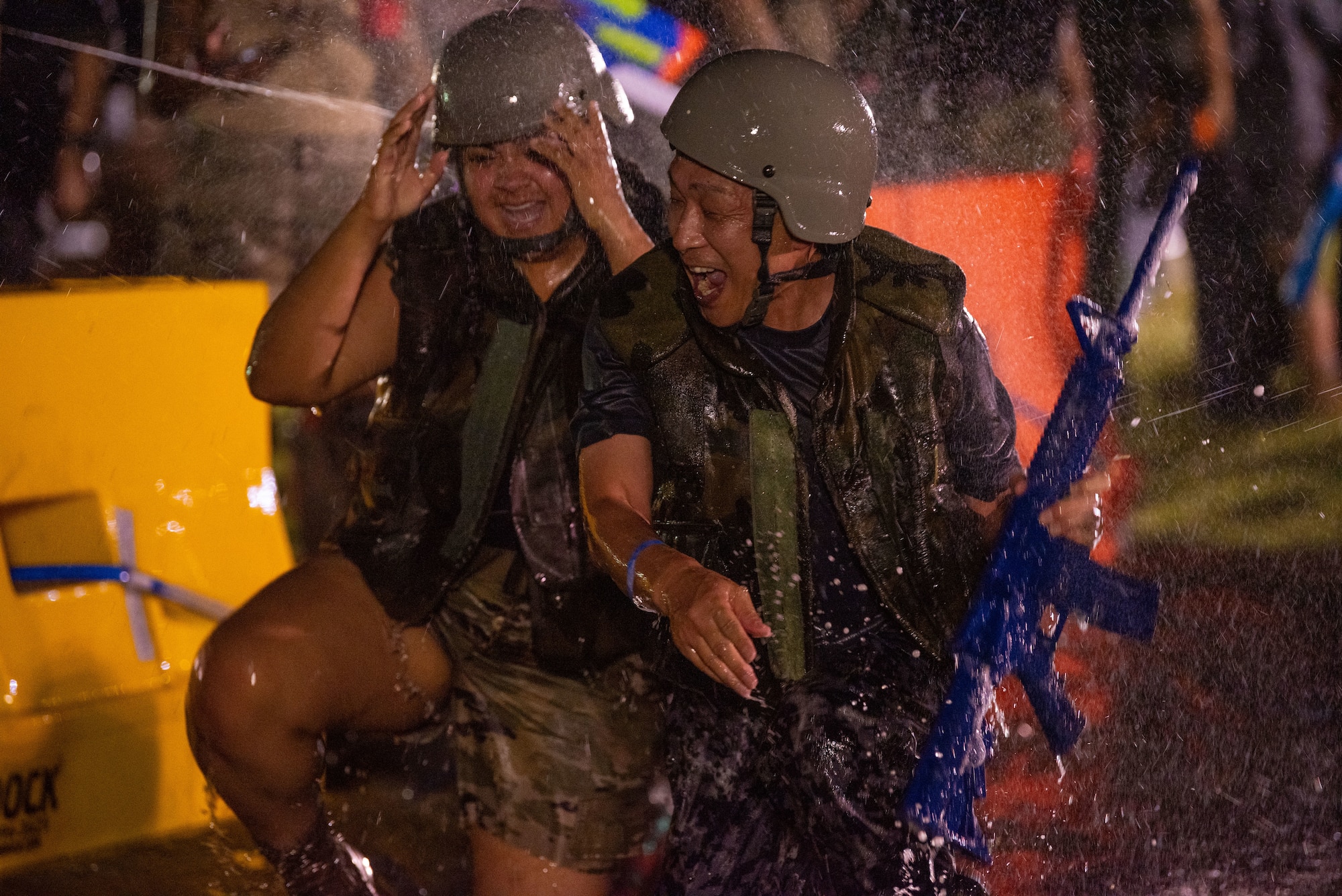Members of Team Misawa laugh as they go through an obstacle course during Misawa’s first joint enlisted bilateral combat dining-in event at Misawa Air Base, Japan, July 28, 2023.