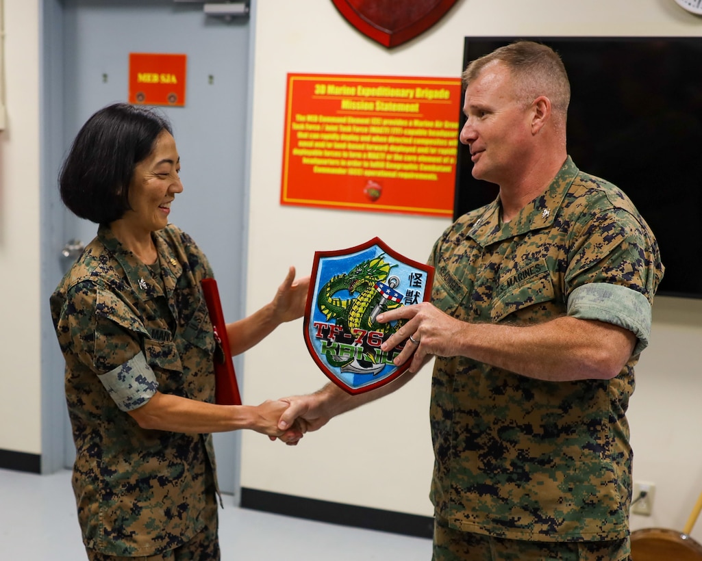 U.S. Marine Col. Clay Readinger, chief of staff, 3rd Marine Expeditionary Brigade, III Marine Expeditionary Force and Task Force 76/3, presents a going-away gift to U.S. Navy Capt. Wendy Mancuso, brigade surgeon, during an awards presentation on Camp Courtney, Okinawa, Japan, Jun. 22, 2023. (U.S. Marine Corps photo by Staff Sgt. Andrew Ochoa)