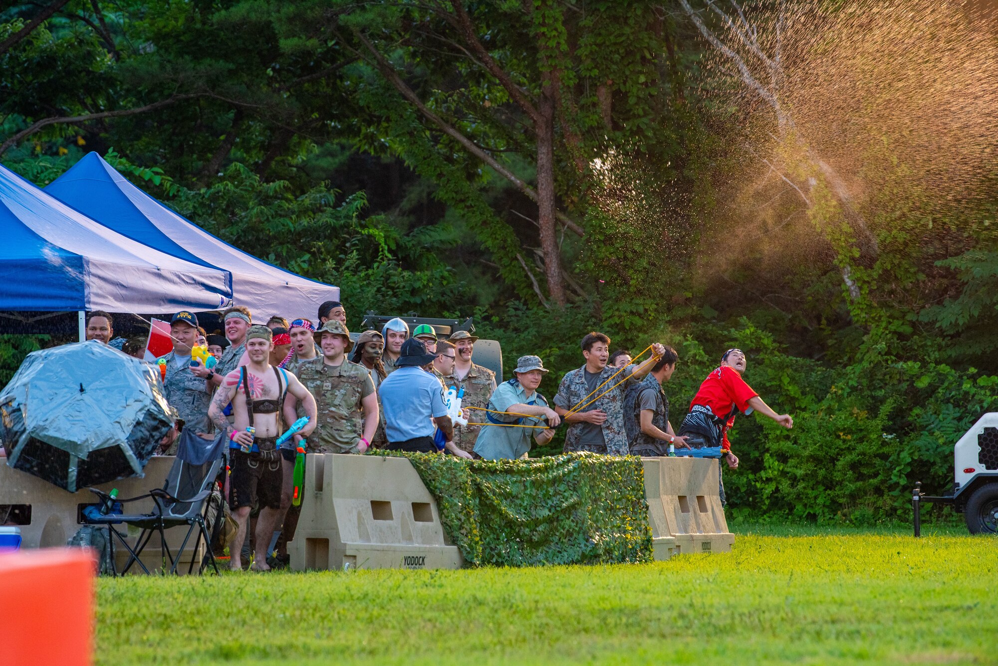 Team Misawa members shoot water at other participants during Misawa’s first joint enlisted bilateral combat dining-in event at Misawa Air Base, Japan, July 28, 2023.