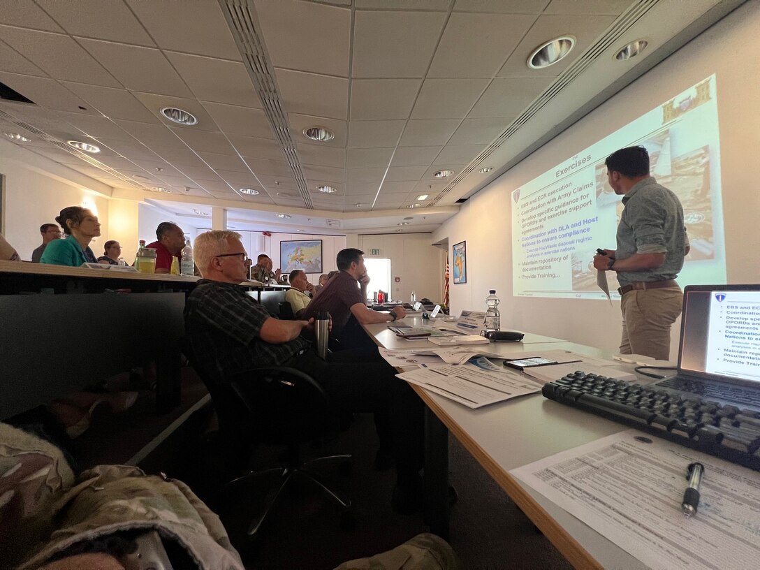 A man gives a presentation to a room full of people.