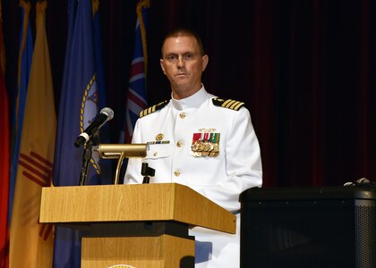 JOINT BASE SAN ANTONIO-FORT SAM HOUSTON – (Aug. 4, 2023) – Capt. Gerald DeLong, Medical Service Corps (MSC), of Belvidere, Ill., speaks to Sailors, Soldiers, and guests after relinquishing command of Naval Medical Research Unit (NAMRU) San Antonio to Capt. Jennifer Buechel, Nurse Corps, of Woodhaven, Mich., during a Change of Command Ceremony held at the Fort Sam Houston Theatre.  Capt. William Deniston, MSC, commander, Naval Medical Research Command (NMRC) presided over the ceremony and Capt. Robert Hawkins, director, J3/5/7, Defense Health Agency (DHA) and director, U.S. Navy Nurse Corps, served as the guest speaker. NAMRU San Antonio’s mission is to conduct gap driven combat casualty care, craniofacial, and directed energy research to improve survival, operational readiness, and safety of Department of Defense (DoD) personnel engaged in routine and expeditionary operations. It is one of the leading research and development laboratories for the U.S. Navy under the DoD and is one of eight subordinate research commands in the global network of laboratories operating under NMRC in Silver Spring, Md. (U.S. Navy photo by Burrell Parmer, NAMRU San Antonio Public Affairs/Released)