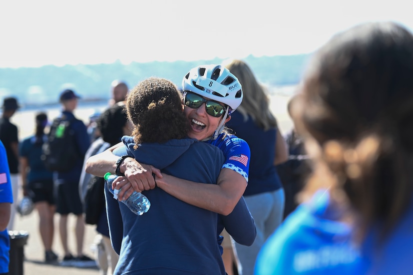 Two women hug.