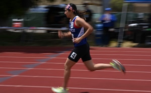 A woman runs on a track.