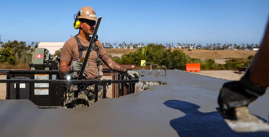 Steelworker First Class Richard Rodriguez, assigned to Naval Mobile Construction Battalion (NMCB) Four, levels a concrete pile cap for the Construction Training Exercise (CTX) Quay Wall Pile Cap Project.