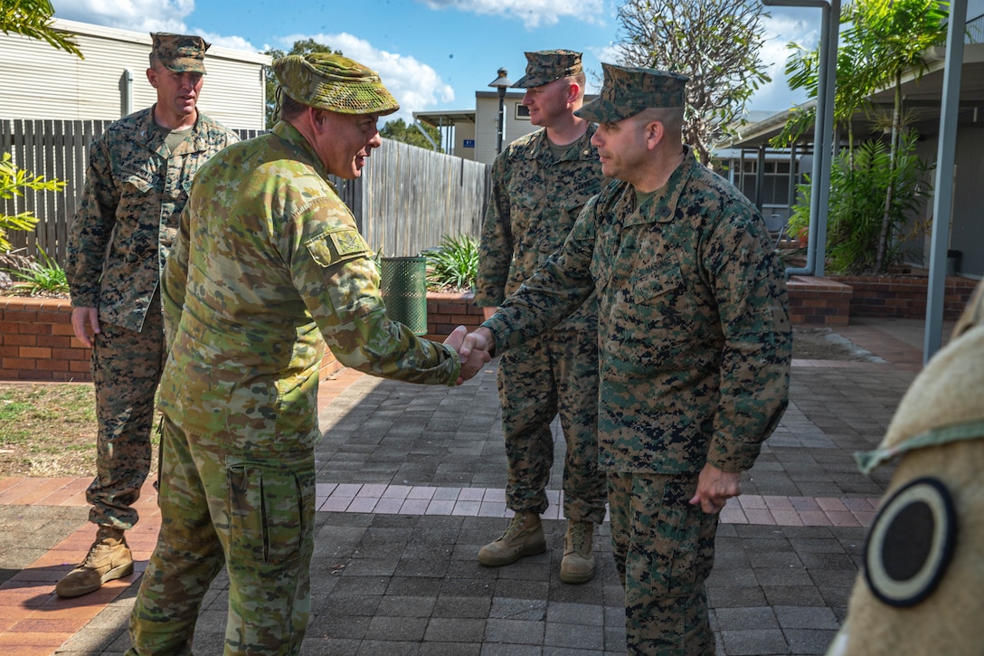 U.S. Marine Corps Master Gunnery Sgt. Robert Robinson, right, the operations chief with 1st Marine Division, greets Royal Australian Army Brigadier Gregory Novak, the 6th Combat Support Brigade commander, before a Talisman Sabre 23 staff brief at Lavarack Barracks in Townsville, Australia, July 20, 2023. Talisman Sabre is the largest bilateral military exercise between Australia and the United States advancing a free and open Indo-Pacific by strengthening relationships and interoperability among key Allies and enhancing our collective capabilities to respond to a wide array of potential security concerns.