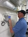 A Pacific Northwest National Laboratory staff member checks an ultrasonic flow meter at B.T. Collins Army Reserve Center in Sacramento, CA. The site is home to a phase change material pilot and an HVAC testbed for controls systems diagnostic tools.