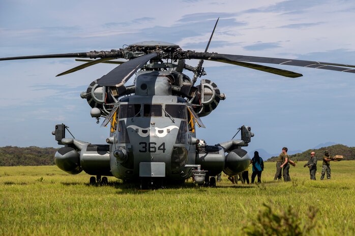 A U.S. Marine Corps CH-53E Super Stallion with Marine Medium Tiltrotor Squadron 163, Marine Aircraft Group 16, 3rd Marine Aircraft Wing is offloaded by U.S. Marines and Filipino citizens during relief efforts in the wake of Typhoon Egay, international name Typhoon Doksuri, on Fuga Island, Philippines, Aug. 3, 2023. At the request of the Armed Forces of the Philippines, U.S. Marines are providing relief and lifesaving capabilities to remote regions of the Philippines. The forward presence and ready posture of I Marine Expeditionary Force assets in the region facilitated rapid and effective response to crisis, demonstrating U.S. commitment to Allies and partners. During the three days of relief efforts, VMM-163 delivered approximately 64,000 pounds of food and water, provided by the Government of the Philippines, to remote, affected communities.