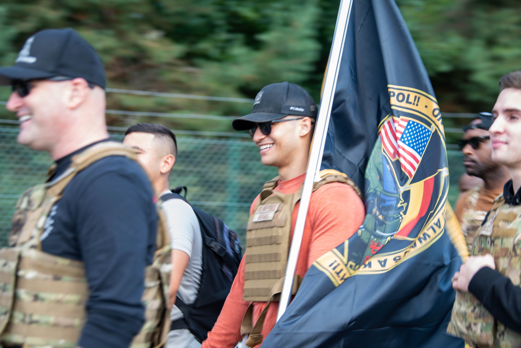 Airman holds flag.