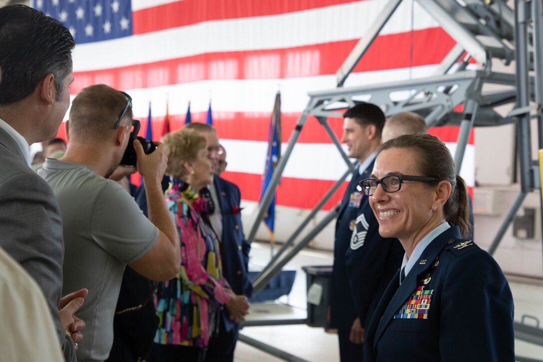 Female Air Force officer smiles at civilian guests