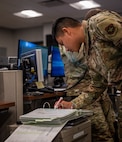 U.S. Air Force Senior Airman Bryan Nunez, 628th Air Base Wing Command Post senior emergency actions controller, runs through a checklist during weather notifications on Joint Base Charleston, South Carolina, July 27, 2023.