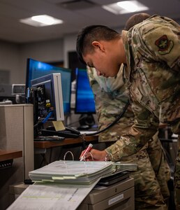 U.S. Air Force Senior Airman Bryan Nunez, 628th Air Base Wing Command Post senior emergency actions controller, runs through a checklist during weather notifications on Joint Base Charleston, South Carolina, July 27, 2023.