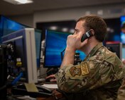 U.S. Air Force Senior Airman Wyatt Swick, 628th Air Base Wing Command Post junior emergency actions controller, calls various squadrons to relay weather notifications on Joint Base Charleston, South Carolina, July 27, 2023.