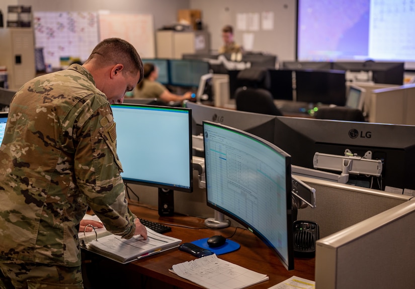 U.S. Air Force Tech. Sgt. Kyle Morales, 628th Air Base Wing Command Post command-and-control operations, reviews procedures during his shift at Joint Base Charleston, South Carolina, July 27, 2023.
