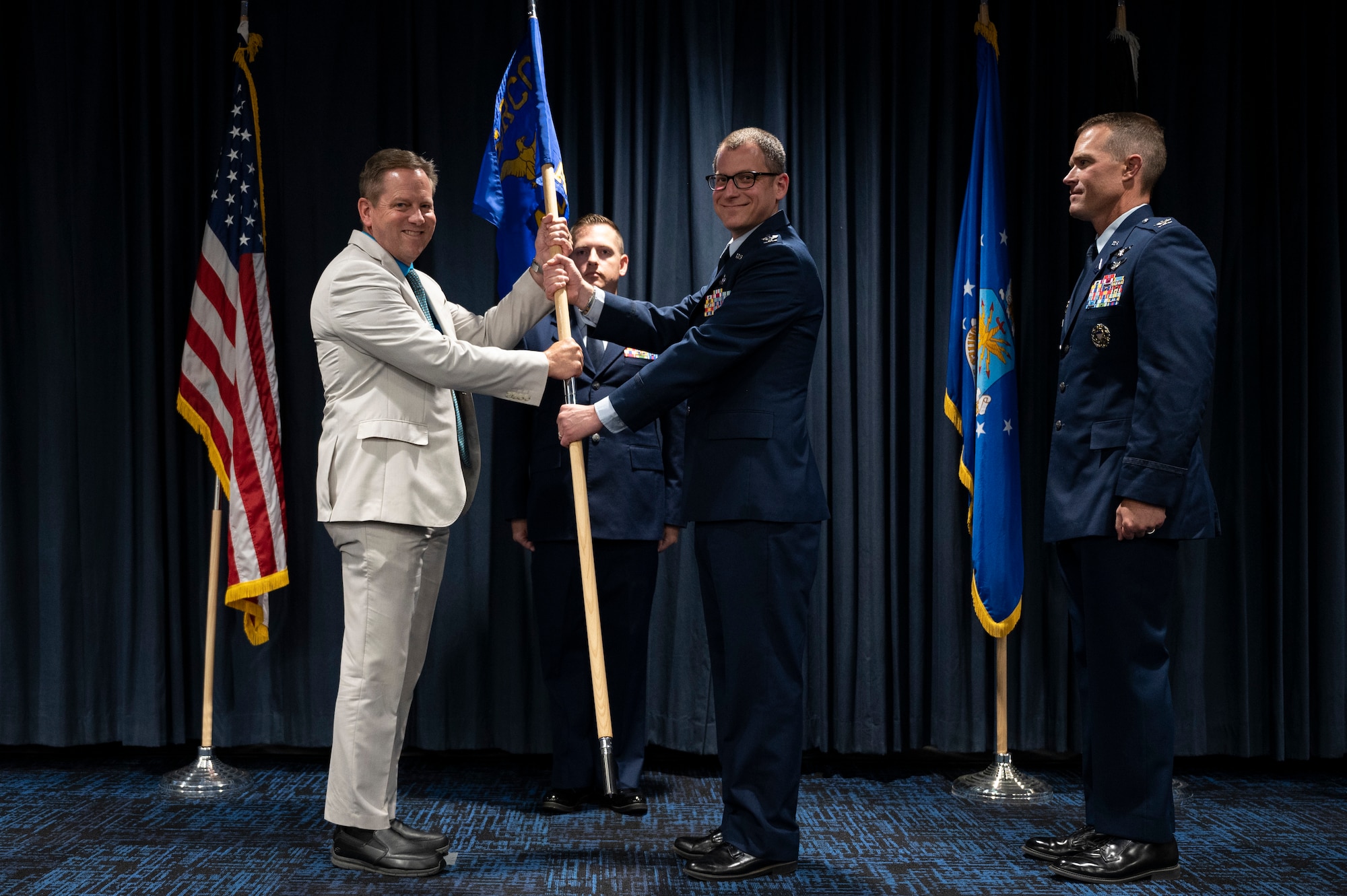 A man passes a guidon.