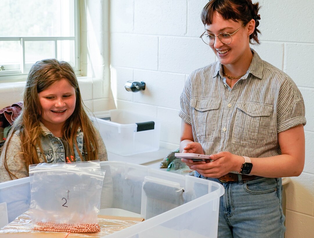 IMAGE: Kelly Morgan, a scientist in the Strategic and Computing Systems Department at Naval Surface Warfare Center Dahlgren Division, tests a boat constructed by youth at the Spotsylvania County Sheriff’s Office STEM Camp July 31 at the Germanna Community College Fredericksburg Area Campus.