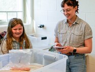 IMAGE: Kelly Morgan, a scientist in the Strategic and Computing Systems Department at Naval Surface Warfare Center Dahlgren Division, tests a boat constructed by youth at the Spotsylvania County Sheriff’s Office STEM Camp July 31 at the Germanna Community College Fredericksburg Area Campus.