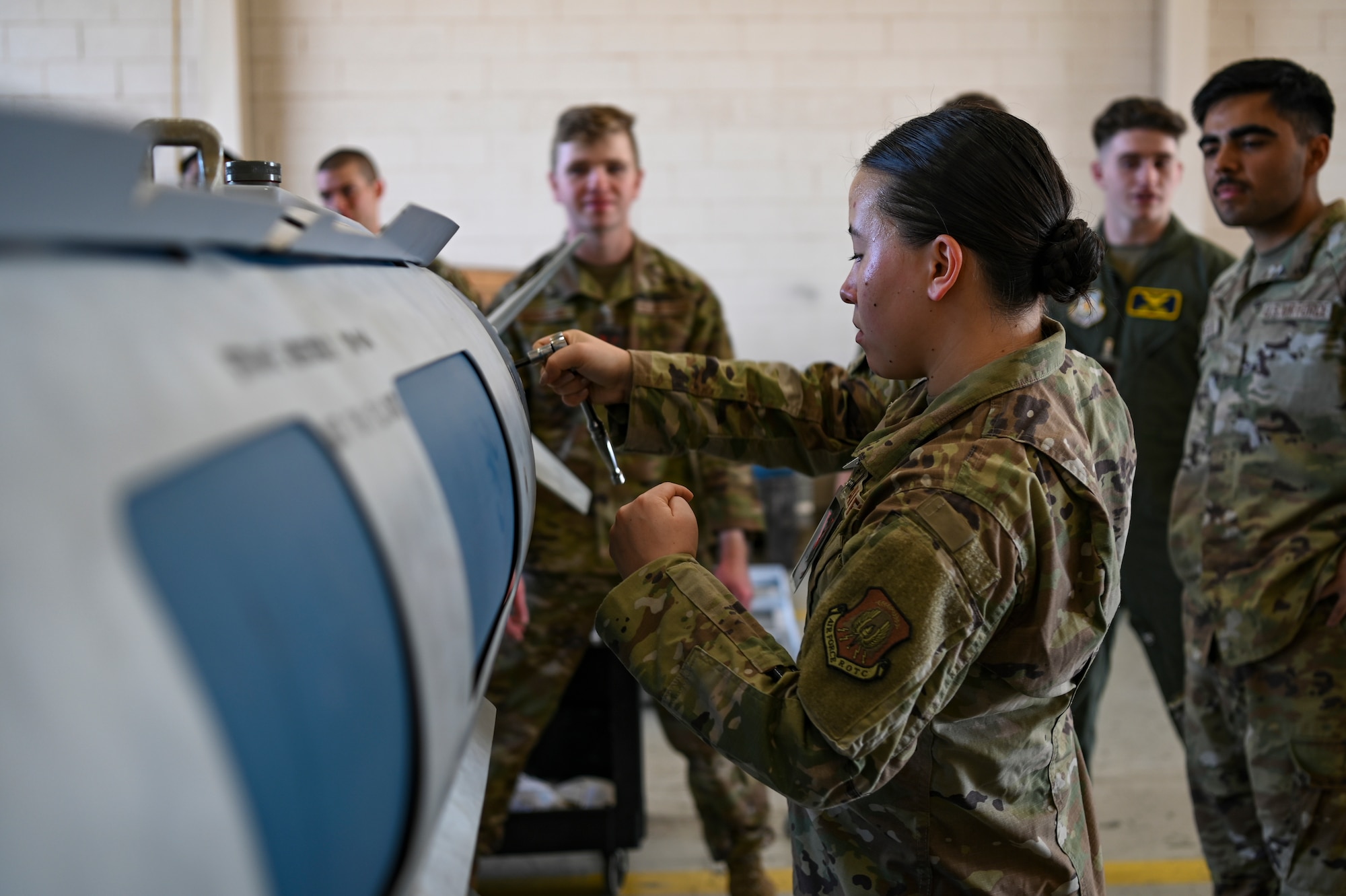Anna Mason, Rochester Institute of Technology Air Force ROTC cadet, tightens a bolt on a munition during Project Tuskegee 2.0 at Dyess Air Force Base, Texas, Aug. 1, 2023. The project is intended to increase the cadets' understanding of Air Force and Space Force missions and day-to-day operations. The 19 cadets in attendance represent 19 different Air Force ROTC detachments across the enterprise's four regions. (U.S. Air Force photo by Airman 1st Class Emma Anderson)