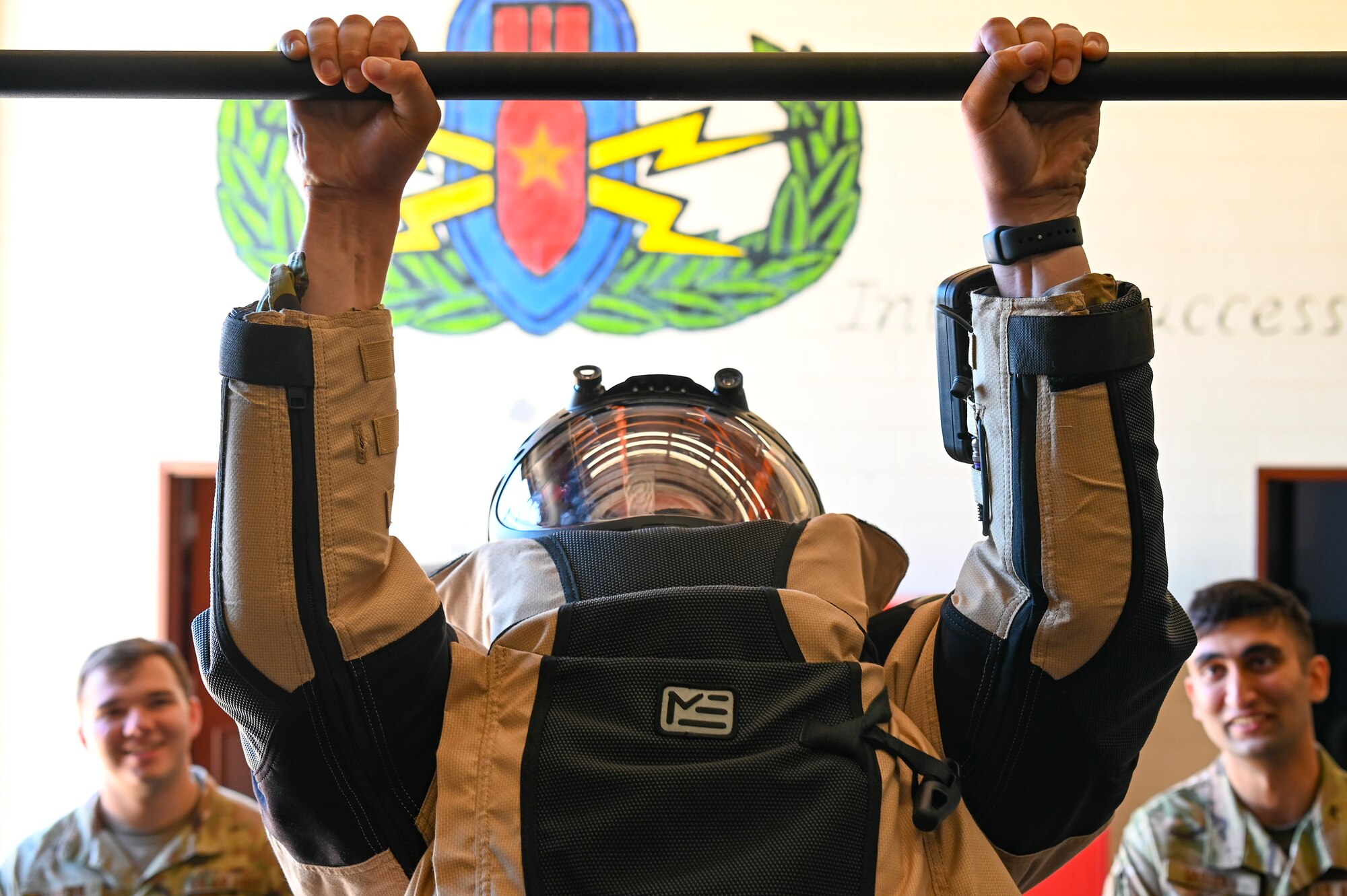 Tristan Lewis, University of Arizona Air Force ROTC cadet, does a pull-up in a bomb suit during Project Tuskegee 2.0 at Dyess Air Force Base, Texas, Aug. 1, 2023. The project is intended to increase the cadets' understanding of Air Force and Space Force missions and day-to-day operations. The 19 cadets in attendance represent 19 different Air Force ROTC detachments across the enterprise's four regions. (U.S. Air Force photo by Airman 1st Class Emma Anderson)