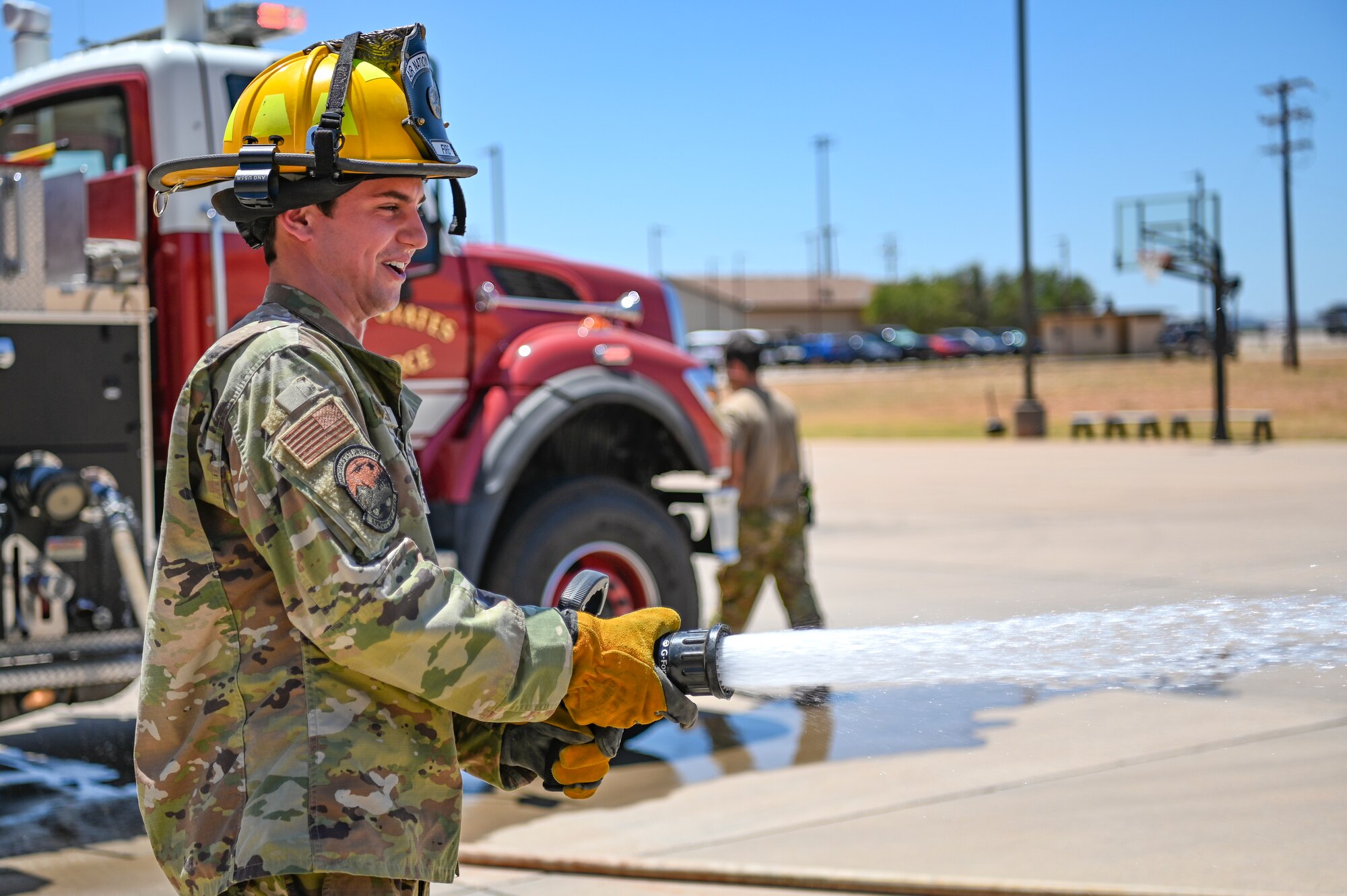 Angelo Donisi, Montana State University Air Force ROTC cadet, uses a fire hose during Project Tuskegee 2.0 at Dyess Air Force Base, Texas, Aug. 1, 2023. The project is intended to increase the cadets' understanding of Air Force and Space Force missions and day-to-day operations. The 19 cadets in attendance represent 19 different Air Force ROTC detachments across the enterprise's four regions. (U.S. Air Force photo by Airman 1st Class Emma Anderson)