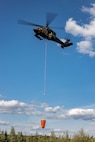 An Alaska Army National Guard UH-60L Black Hawk helicopter assigned to 207th Aviation Troop Command operates near Ladd Army Airfield Aug. 3., 2023 in support of wildland fire suppression across Interior Alaska. During fire suppression operations, the UH-60 employs a Bambi Bucket filled with approximately 630 gallons of water from a nearby lake. The Alaska Army National Guard deployed the UH-60 and air crew July 31, 2023 after receiving a resource request from the Alaska Division of Forestry and Fire Protection routed through the State Emergency Operations Center.