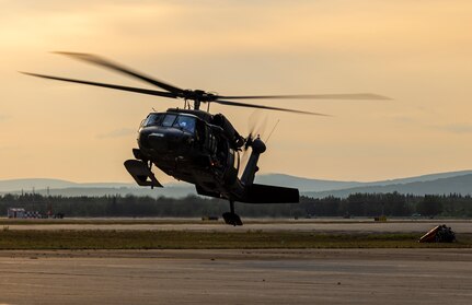 An Alaska Army National Guard UH-60L Black Hawk helicopter assigned to 207th Aviation Troop Command operates near Ladd Army Airfield Aug. 3., 2023 in support of wildland fire suppression across Interior Alaska. During fire suppression operations, the UH-60 employs a Bambi Bucket filled with approximately 630 gallons of water from a nearby lake. The Alaska Army National Guard deployed the UH-60 and air crew July 31, 2023 after receiving a resource request from the Alaska Division of Forestry and Fire Protection routed through the State Emergency Operations Center.