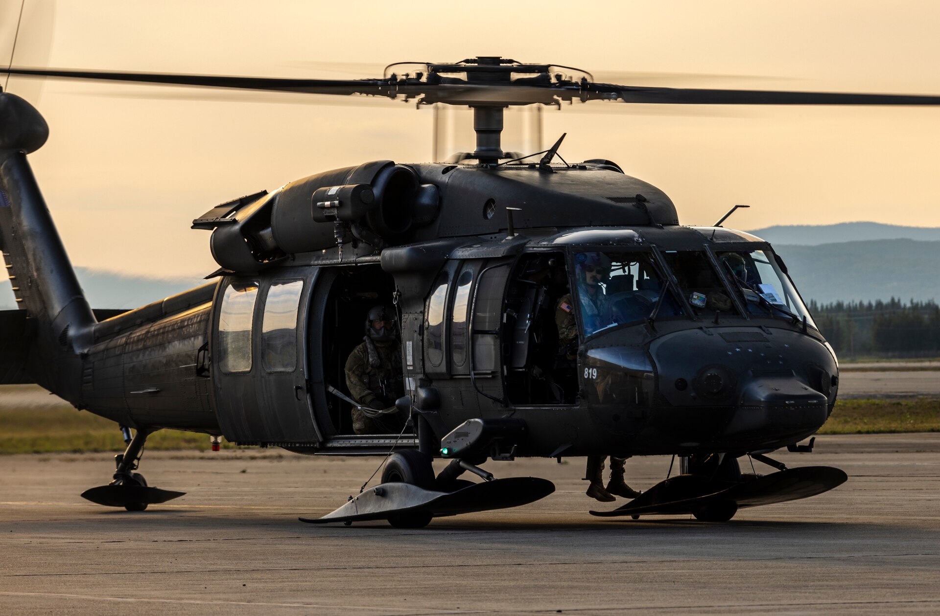 An Alaska Army National Guard UH-60L Black Hawk helicopter assigned to 207th Aviation Troop Command operates near Ladd Army Airfield Aug. 3., 2023 in support of wildland fire suppression across Interior Alaska. During fire suppression operations, the UH-60 employs a Bambi Bucket filled with approximately 630 gallons of water from a nearby lake. The Alaska Army National Guard deployed the UH-60 and air crew July 31, 2023 after receiving a resource request from the Alaska Division of Forestry and Fire Protection routed through the State Emergency Operations Center.