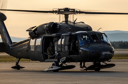 An Alaska Army National Guard UH-60L Black Hawk helicopter assigned to 207th Aviation Troop Command operates near Ladd Army Airfield Aug. 3., 2023 in support of wildland fire suppression across Interior Alaska. During fire suppression operations, the UH-60 employs a Bambi Bucket filled with approximately 630 gallons of water from a nearby lake. The Alaska Army National Guard deployed the UH-60 and air crew July 31, 2023 after receiving a resource request from the Alaska Division of Forestry and Fire Protection routed through the State Emergency Operations Center.