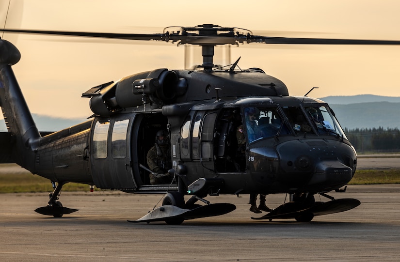 An Alaska Army National Guard UH-60L Black Hawk helicopter assigned to 207th Aviation Troop Command operates near Ladd Army Airfield Aug. 3., 2023 in support of wildland fire suppression across Interior Alaska. During fire suppression operations, the UH-60 employs a Bambi Bucket filled with approximately 630 gallons of water from a nearby lake. The Alaska Army National Guard deployed the UH-60 and air crew July 31, 2023 after receiving a resource request from the Alaska Division of Forestry and Fire Protection routed through the State Emergency Operations Center.