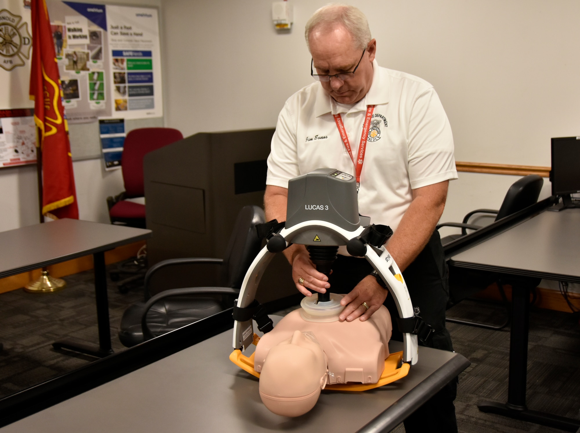 Arnold Air Force Base Fire and Emergency Services Assistant Fire Chief Jim Evans demonstrates the LUCAS 3 Chest Compression System July 17, 2023, at Arnold AFB, Tenn. Arnold FES was able to acquire two of the automated CPR devices through Arnold Engineering Development Complex Spark Tank funding the department received earlier this year. Arnold AFB is the headquarters of AEDC. The LUCAS 3 is designed to deliver uninterrupted chest compressions at a consistent rate and depth, whether in the field, during transport and throughout arrival to the hospital. (U.S. Air Force photo by Bradley Hicks) (This image has been altered by obscuring a badge for security purposes.)