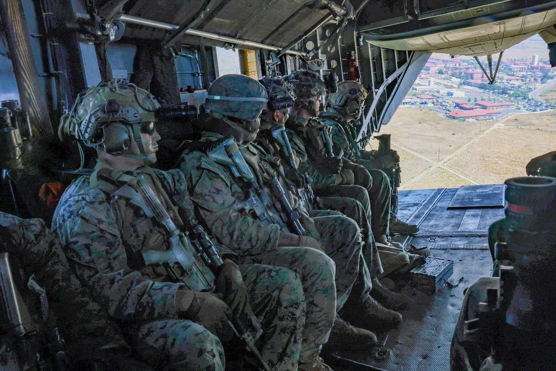 U.S. Marines assigned to Charlie Company, Battalion Landing Team 1/5, 15th Marine Expeditionary Unit, ride in a CH-53E Super Stallion assigned to Marine Medium Tiltrotor Squadron (VMM) 165 (Reinforced), 15th MEU, during a helicopter raid as part of an amphibious raid course at Marine Corps Base Camp Pendleton, California, July 26, 2023. The raid course, taught by Expeditionary Operations Training Group, I Marine Expeditionary Force, is designed to teach and evaluate MEU forces’ capabilities to complete effective raids to seize an area to deny enemy actions and potentially provide information for future operations. (U.S. Marine Corps photo by Cpl. Hekker)