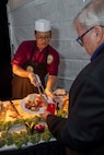 230805-N-YF131-1345 SEATTLE (Aug. 5, 2023) Culinary Specialist 3rd Class Randall Ramis, from Hialeah, Fla., assigned to the Arleigh burke-class guided-missile destroyer USS Barry (DDG 52), serves food at the Seattle Fleet Week closing reception. Seattle Fleet Week is a time-honored celebration of the sea services and provides an opportunity for the citizens of Washington to meet Sailors, Marines and Coast Guardsmen, as well as witness firsthand the latest capabilities of today’s U.S. and Canadian maritime services. (U.S. Navy photo by Mass Communication Specialist 2nd Class Madison Cassidy)