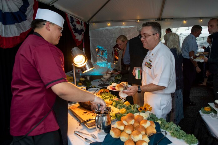 230805-N-YF131-1347 SEATTLE (Aug. 5, 2023) Culinary Specialist 2nd Class Richard Conchas, from Bakersfield, Calif., assigned to the Arleigh burke-class guided-missile destroyer USS Barry (DDG 52), serves food at the Seattle Fleet Week closing reception. Seattle Fleet Week is a time-honored celebration of the sea services and provides an opportunity for the citizens of Washington to meet Sailors, Marines and Coast Guardsmen, as well as witness firsthand the latest capabilities of today’s U.S. and Canadian maritime services. (U.S. Navy photo by Mass Communication Specialist 2nd Class Madison Cassidy)