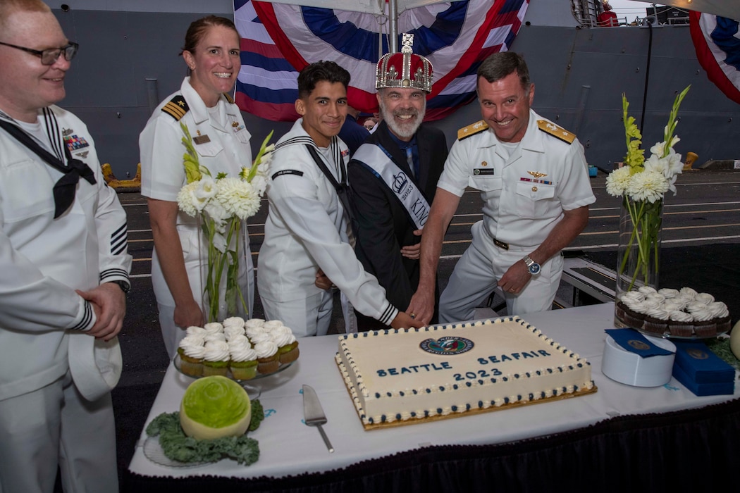 230805-N-YF131-1408 SEATTLE (Aug. 5, 2023) Sailors and civilians cut the cake at the Seattle Fleet Week closing reception hosted by the Arleigh burke-class guided-missile destroyer USS Barry (DDG 52). Seattle Fleet Week is a time-honored celebration of the sea services and provides an opportunity for the citizens of Washington to meet Sailors, Marines and Coast Guardsmen, as well as witness firsthand the latest capabilities of today’s U.S. and Canadian maritime services. (U.S. Navy photo by Mass Communication Specialist 2nd Class Madison Cassidy)