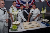 230805-N-YF131-1408 SEATTLE (Aug. 5, 2023) Sailors and civilians cut the cake at the Seattle Fleet Week closing reception hosted by the Arleigh burke-class guided-missile destroyer USS Barry (DDG 52). Seattle Fleet Week is a time-honored celebration of the sea services and provides an opportunity for the citizens of Washington to meet Sailors, Marines and Coast Guardsmen, as well as witness firsthand the latest capabilities of today’s U.S. and Canadian maritime services. (U.S. Navy photo by Mass Communication Specialist 2nd Class Madison Cassidy)